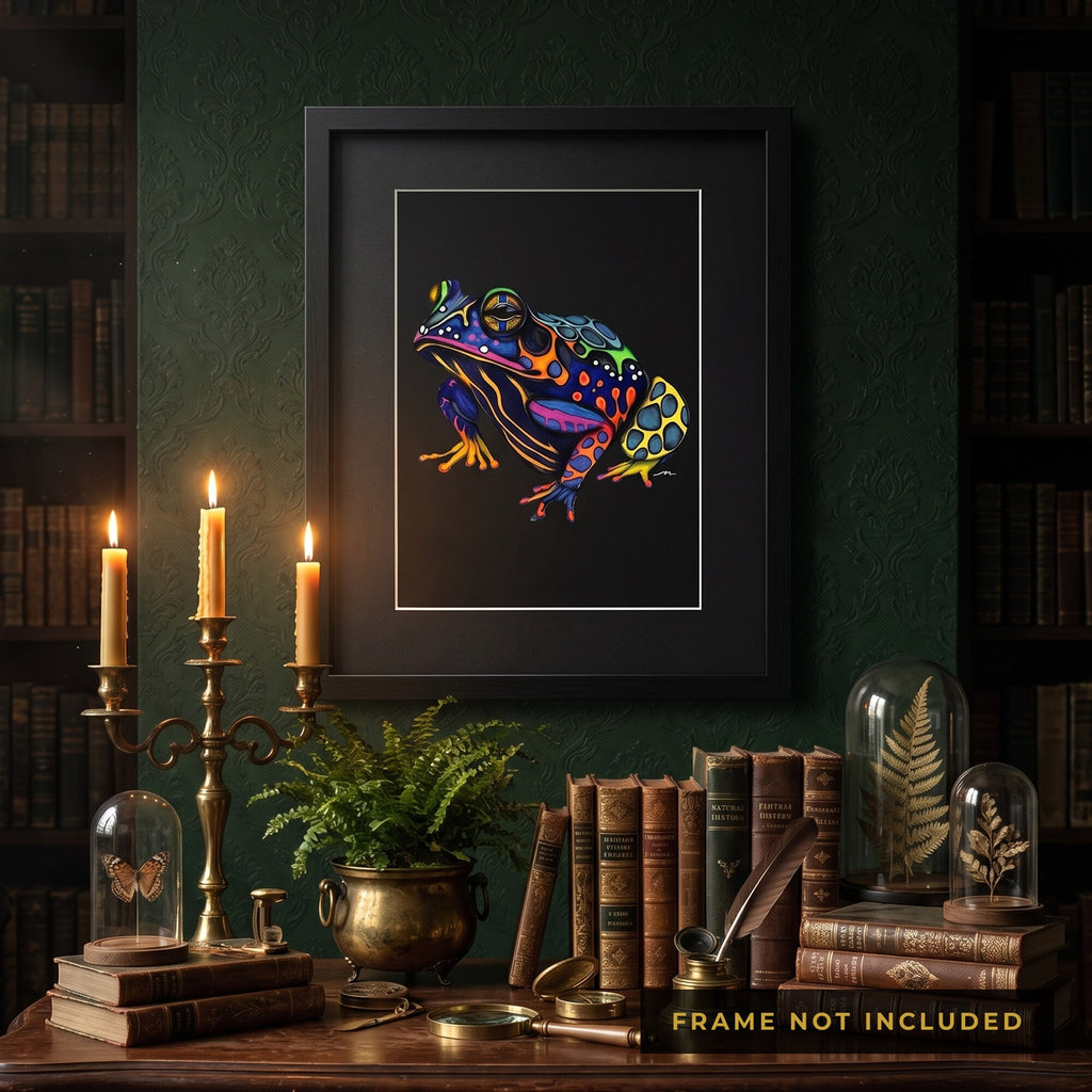 The Psychedelic Frog print framed in black beside candlelight and antique books