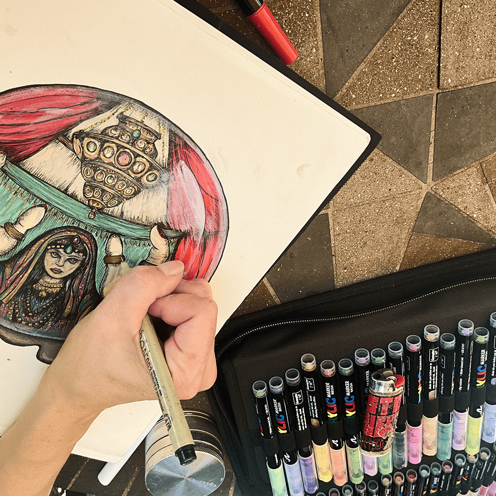 The Fortune Teller being drawn by hand, the acrylic marker set alongside