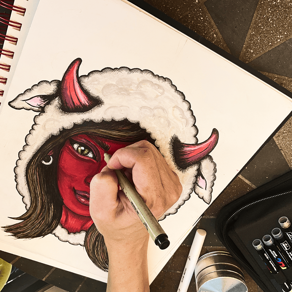 A fine-point ink pen working the horn and fleece hood of the Mama Shilli drawing
